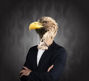 Portrait of businessman with eagle face on dark background