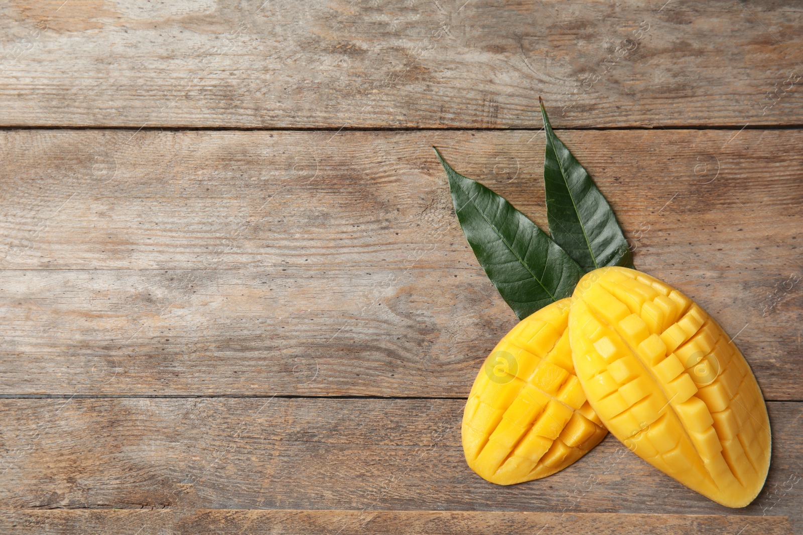 Photo of Flat lay composition with mango on wooden background. Space for text