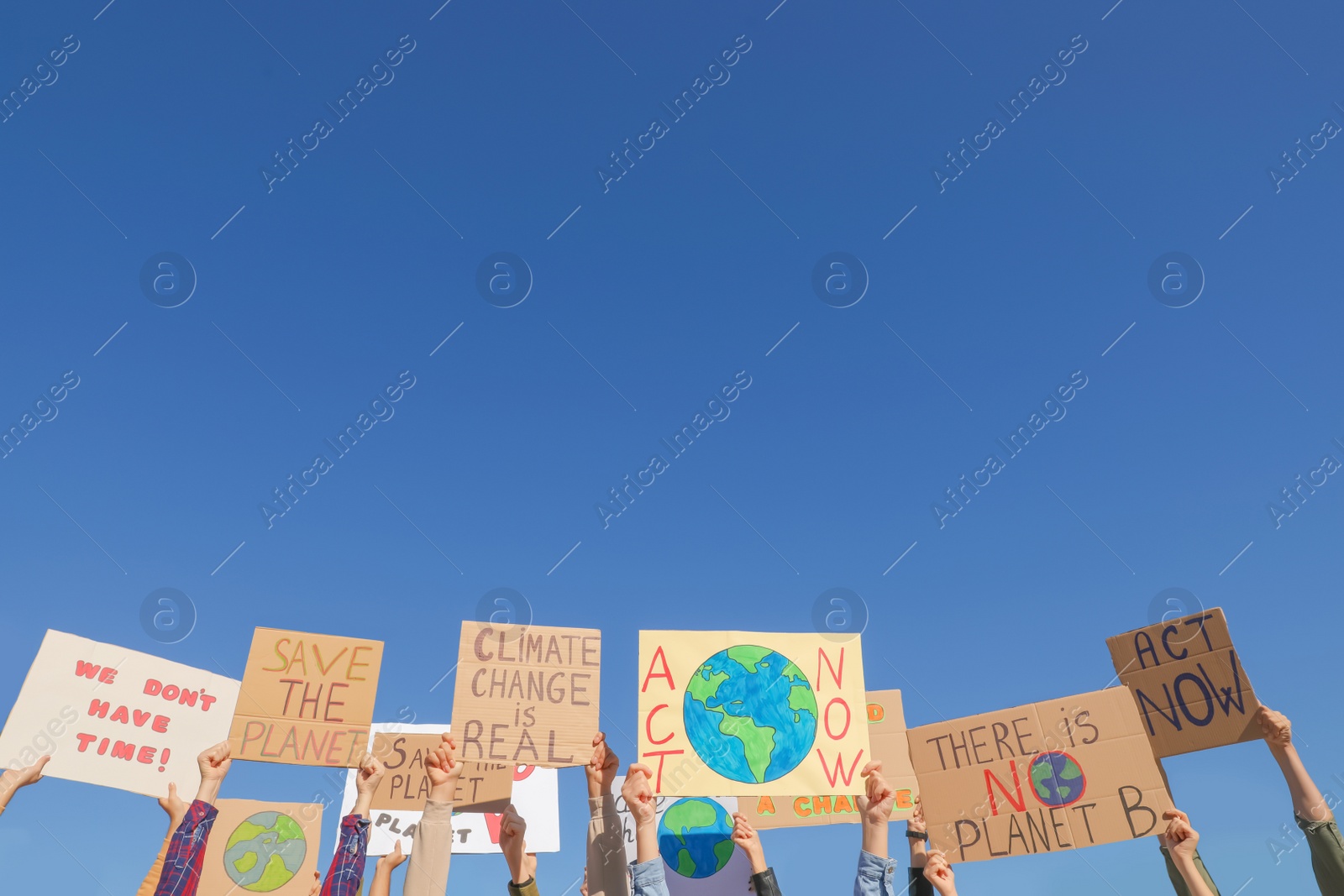 Photo of Group of people with posters protesting against climate change outdoors, closeup