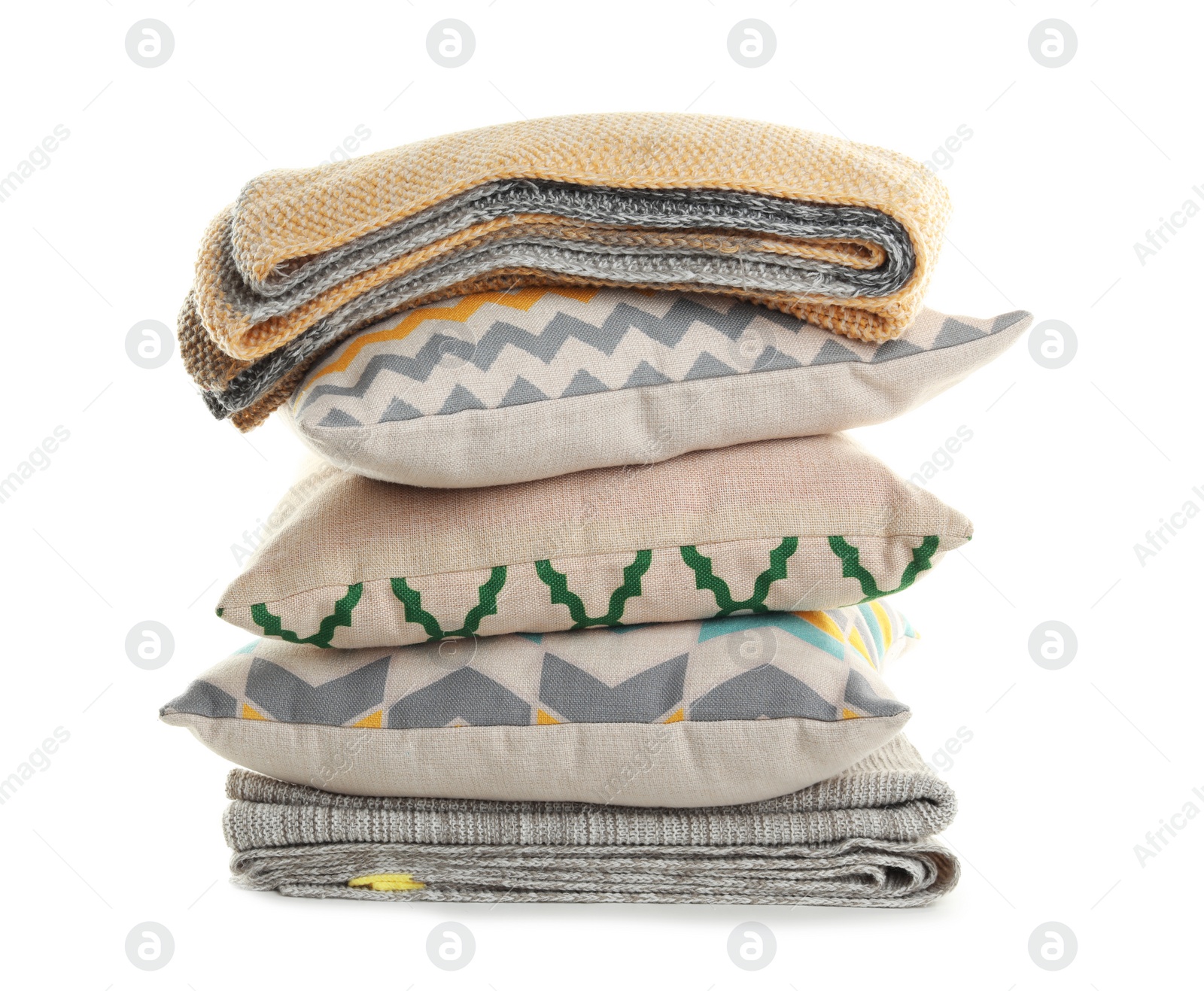 Photo of Stylish soft pillows and folded plaid on white background