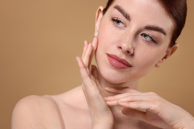 Portrait of beautiful woman on beige background, closeup