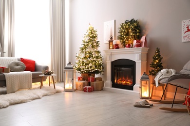 Photo of Stylish living room interior with beautiful fireplace, Christmas tree