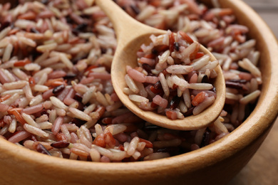 Photo of Delicious brown rice in bowl, closeup view