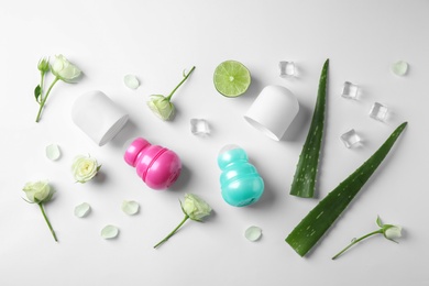 Photo of Composition with female roll-on deodorants on white background, top view