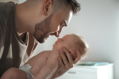 Photo of Father with his newborn son at home, closeup
