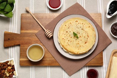 Delicious crepes and different products on table, flat lay