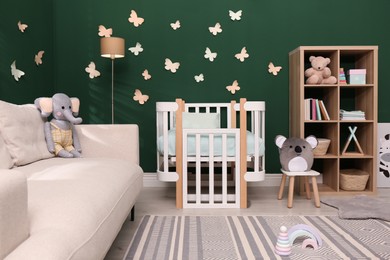 Beautiful baby room interior with comfortable crib and toys