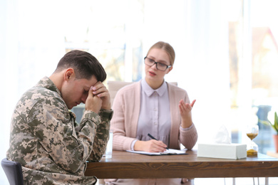 Photo of Psychotherapist working with military officer in office