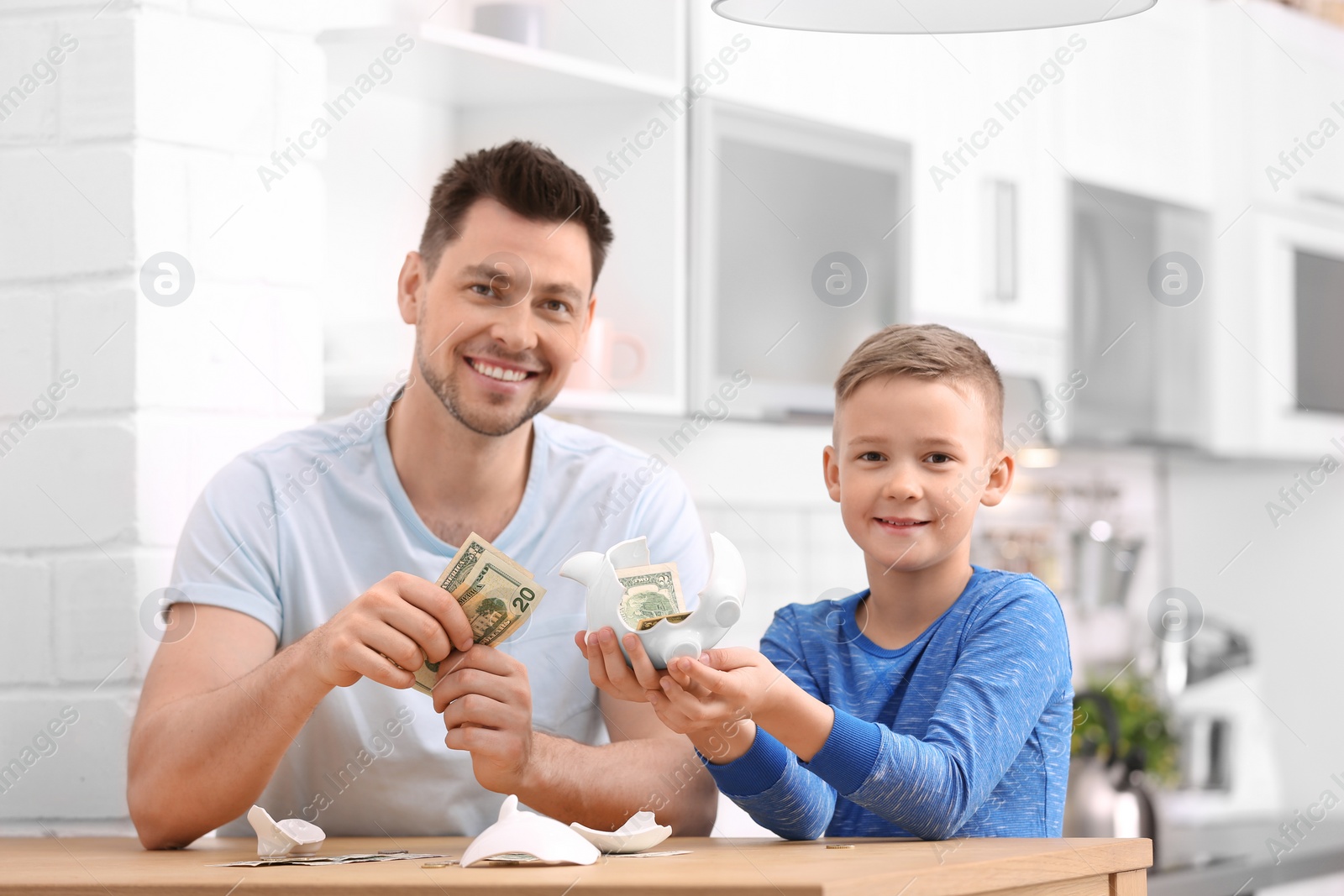 Photo of Family with broken piggy bank and money at home