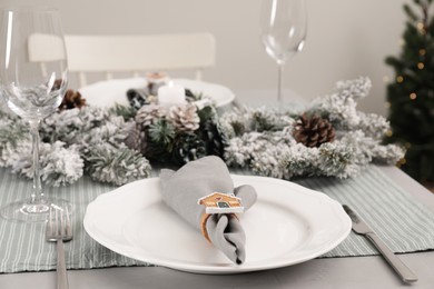 Festive place setting with beautiful dishware, cutlery and fabric napkin for Christmas dinner on grey table