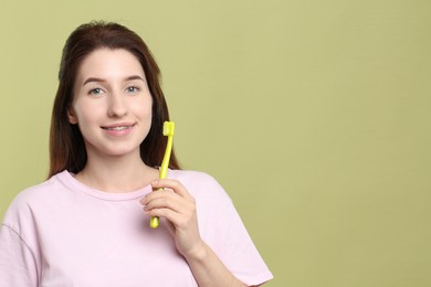 Photo of Portrait of smiling woman with dental braces and toothbrush on light green background. Space for text