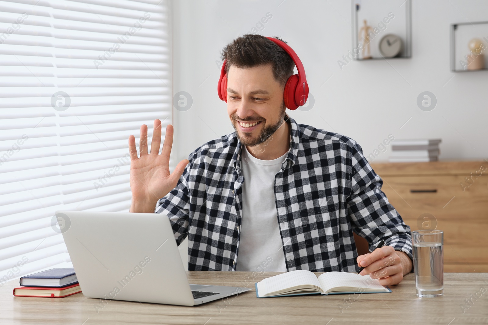 Photo of Man studying on laptop at home. Online translation course