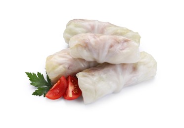 Photo of Uncooked stuffed cabbage rolls, tomato and parsley isolated on white