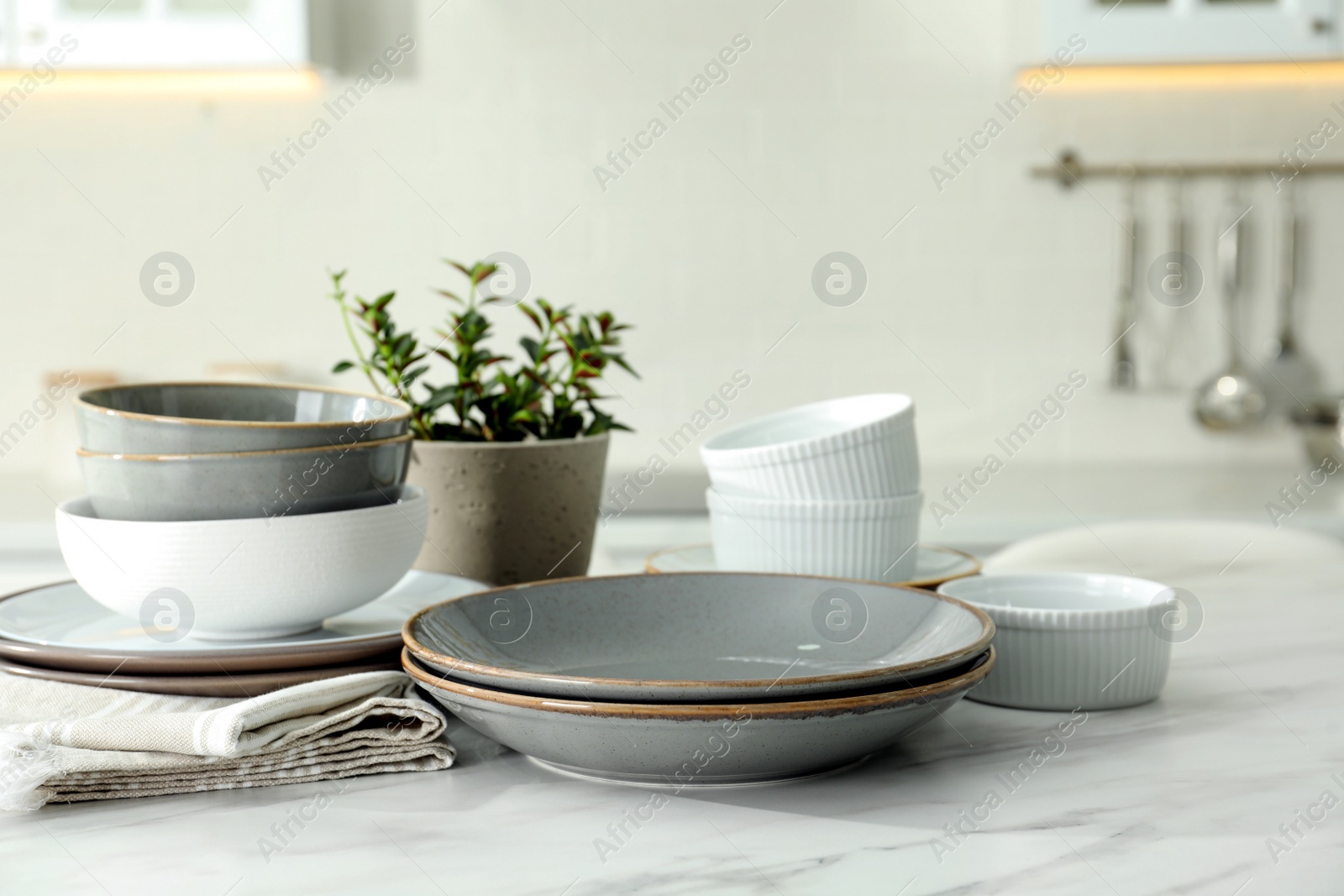 Photo of Set of beautiful ceramic tableware on white table in kitchen