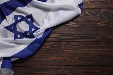 Flag of Israel on wooden background, top view and space for text. National symbol