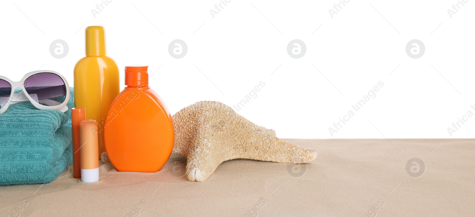 Photo of Sun protection cosmetic products and beach accessories on sand. Space for text