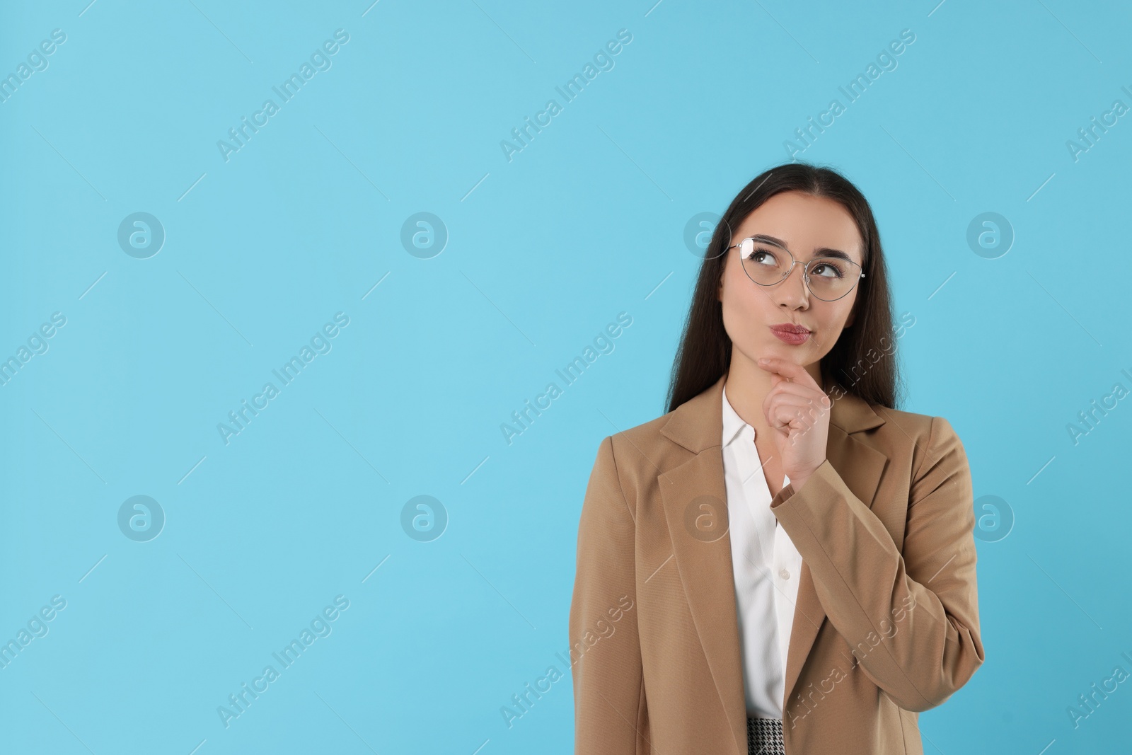 Photo of Curious woman wearing glasses on turquoise background, space for text