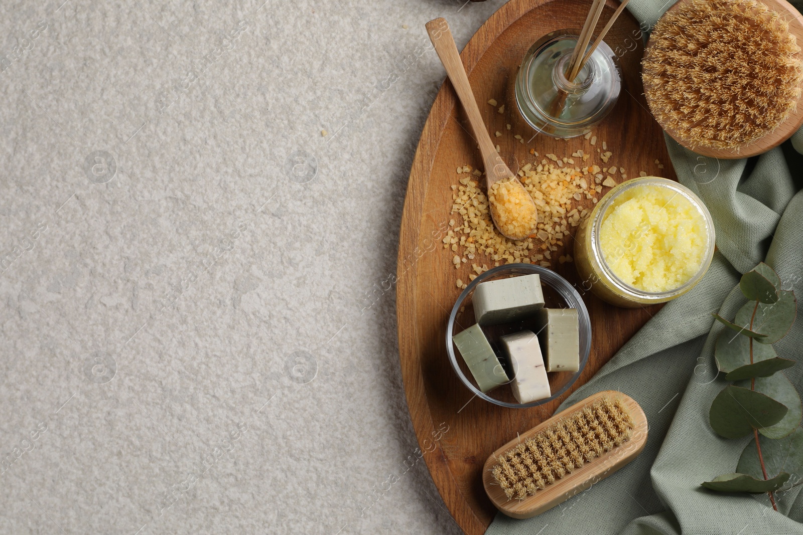 Photo of Composition with different spa products and reed air freshener on light grey textured table, top view. Space for text