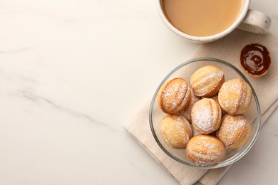 Photo of Homemade walnut shaped cookies with boiled condensed milk and coffee on white marble table, flat lay. Space for text