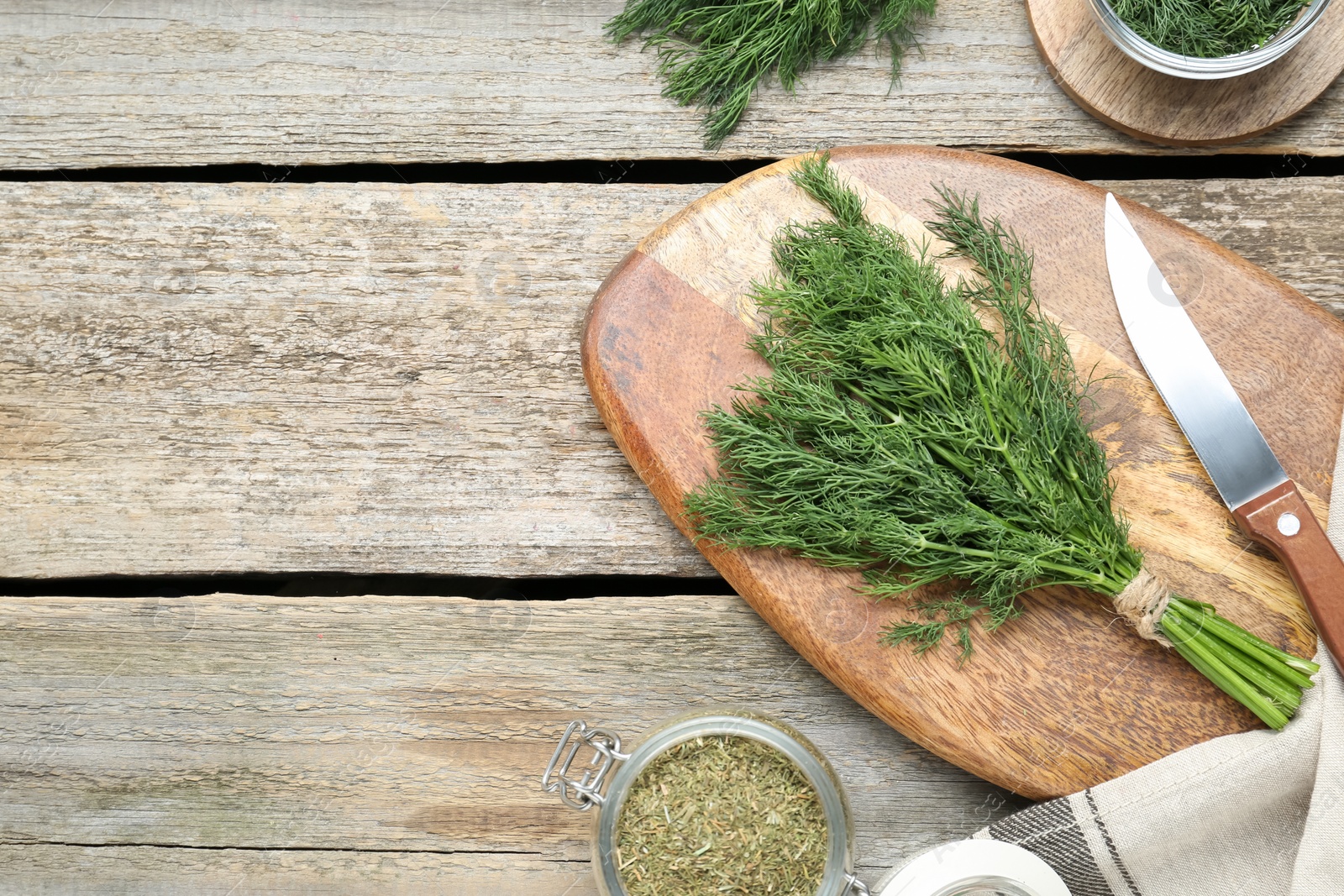 Photo of Fresh dill preparing for drying on wooden table, flat lay. Space for text