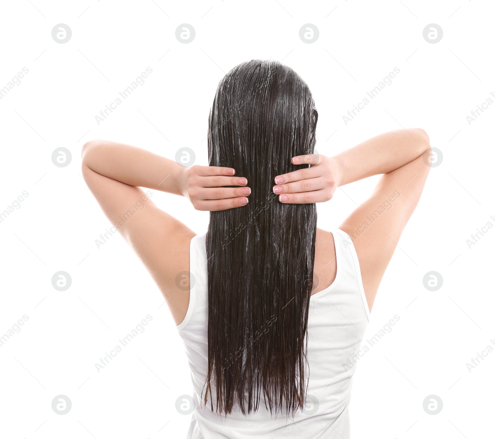 Photo of Young woman applying mask onto hair against white background