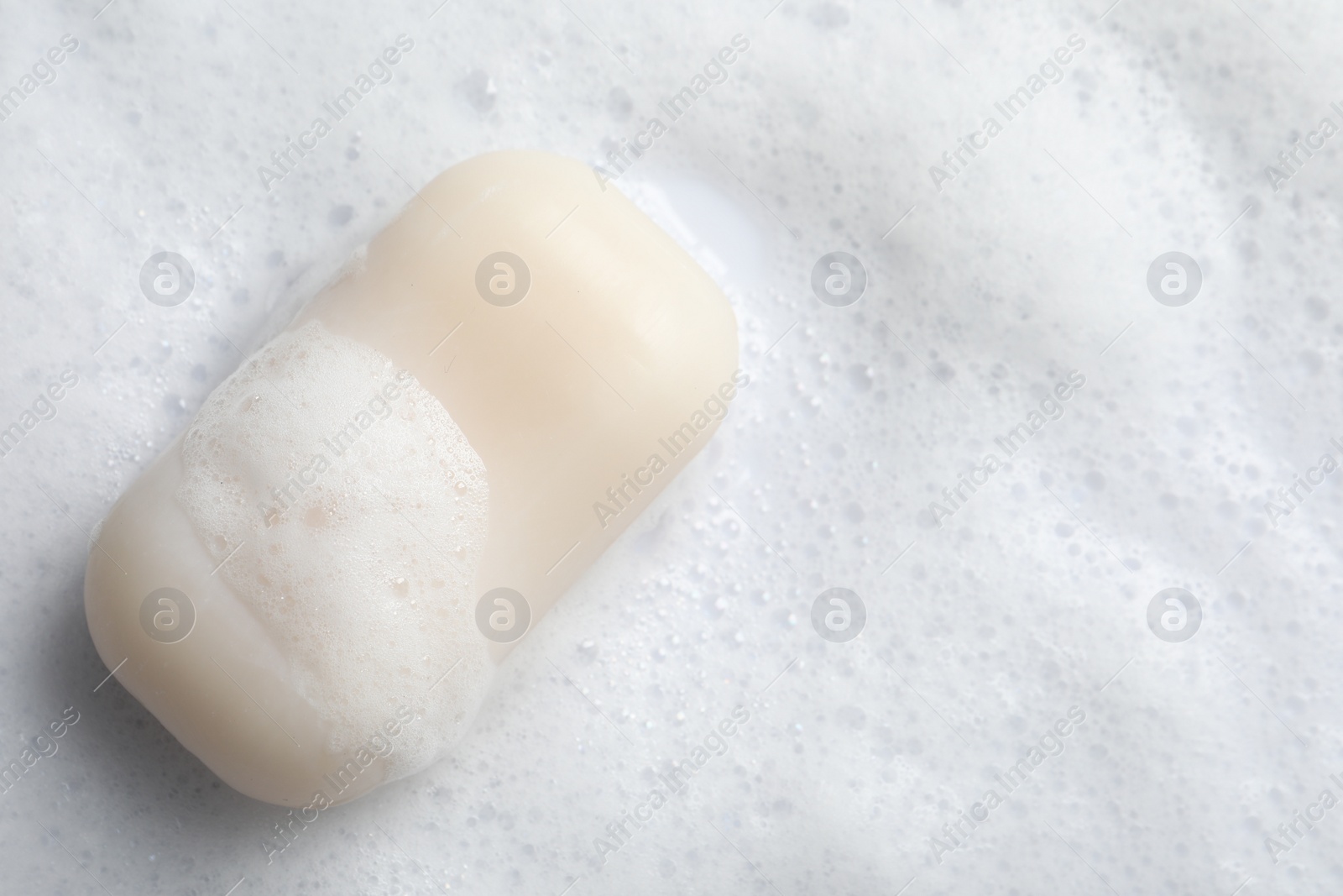 Photo of Top view of soap and fluffy foam