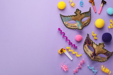 Photo of Flat lay composition with carnival items on violet background. Space for text