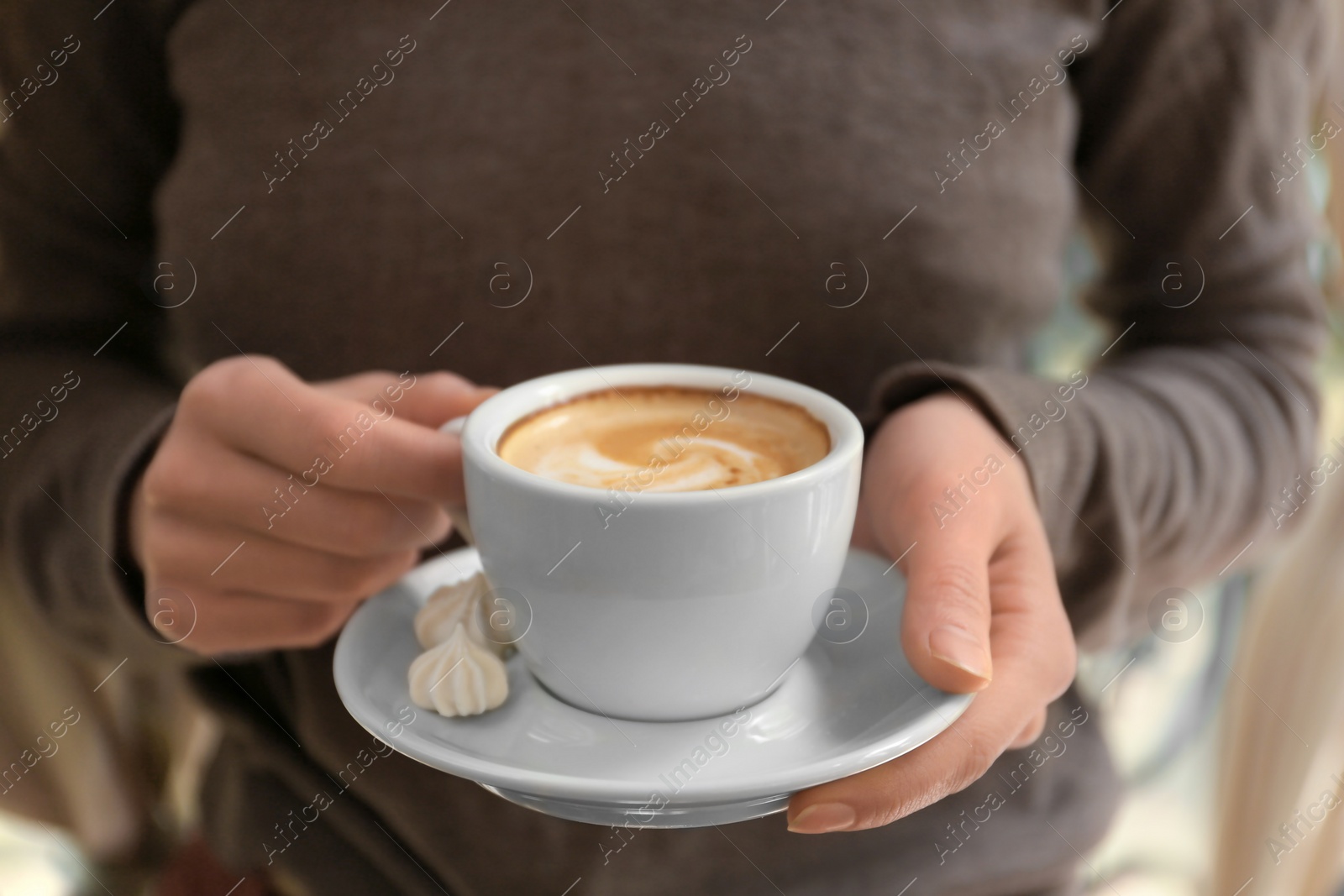 Photo of Young woman with cup of delicious coffee, closeup