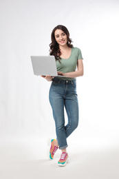 Young woman with laptop on white background