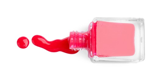 Photo of Overturned bottle of bright nail polish isolated on white, top view