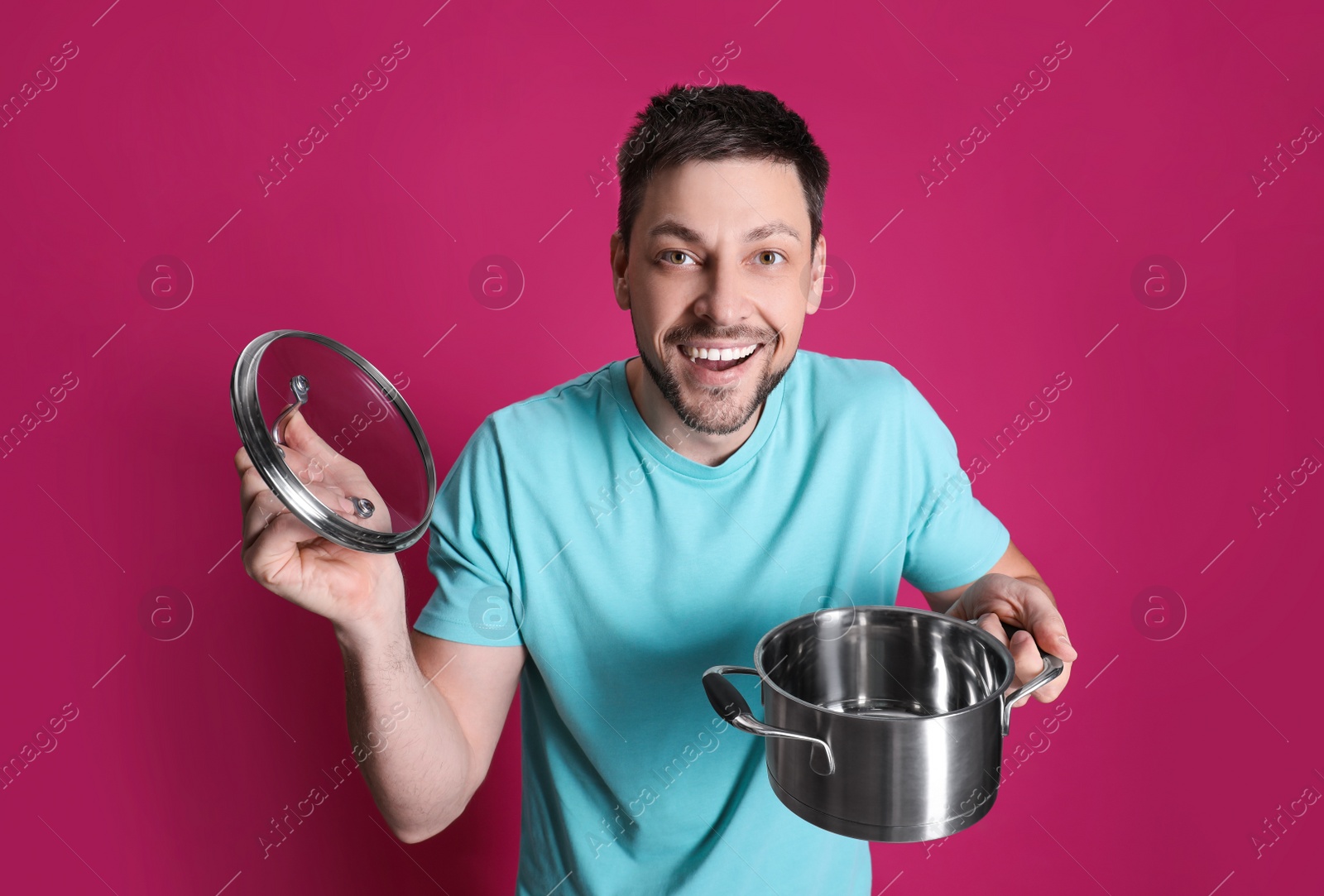 Photo of Happy man with pot on pink background