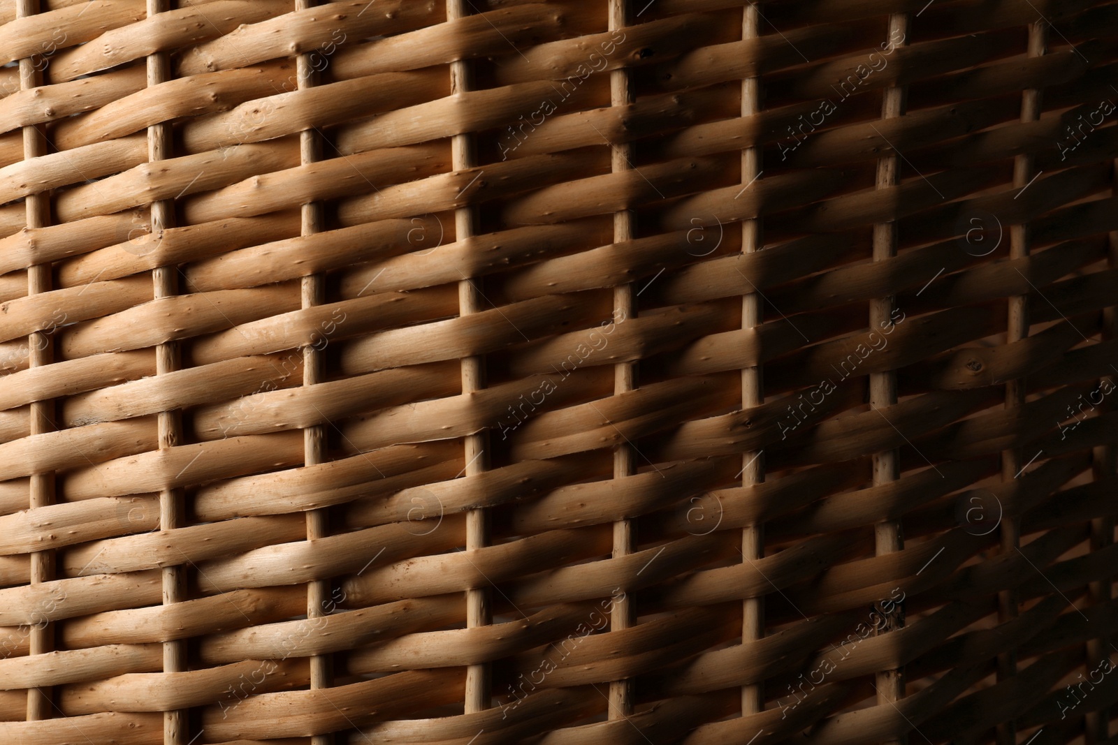 Photo of Handmade wicker basket made of natural material as background, closeup view