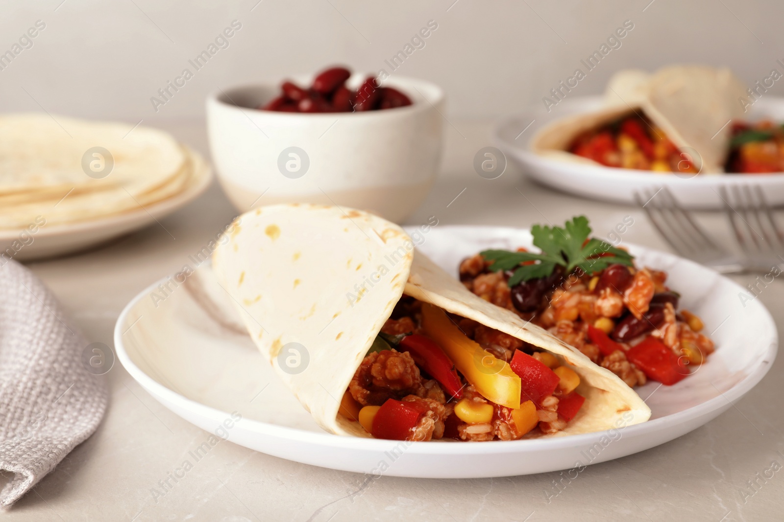 Photo of Chili con carne served with tortilla on table