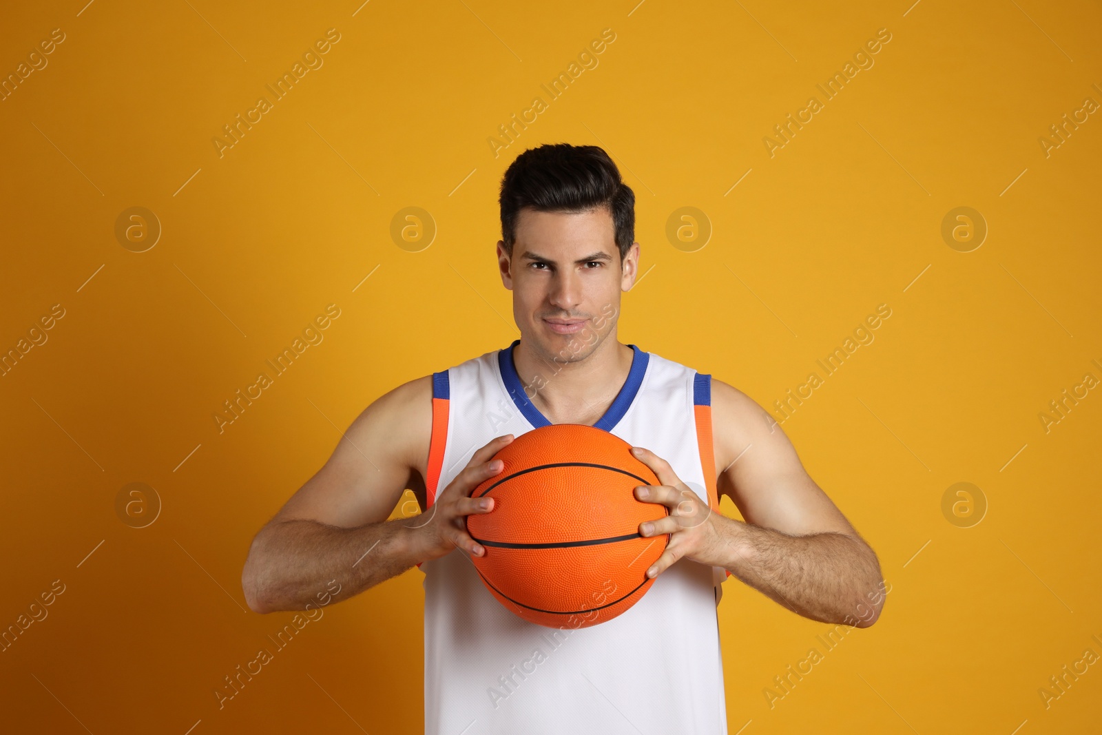 Photo of Basketball player with ball on yellow background