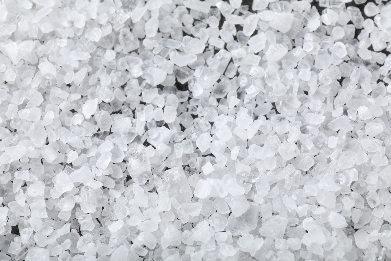 Photo of White natural salt as background, top view