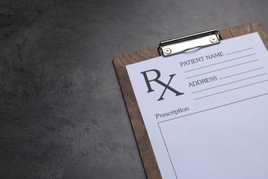 Photo of Clipboard with medical prescription form on dark grey table. Space for text