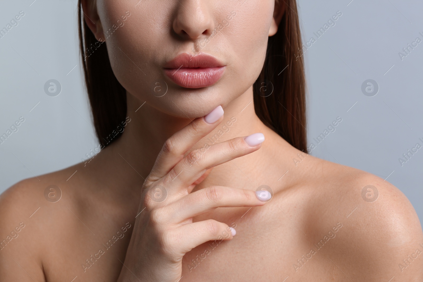 Photo of Woman with beautiful lips on light grey background, closeup