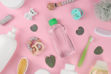 Flat lay composition with baby care products and accessories on pink background