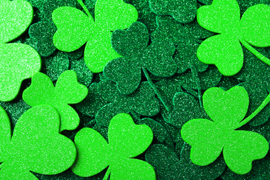Photo of Green clover leaves as background, top view. St. Patrick's Day celebration