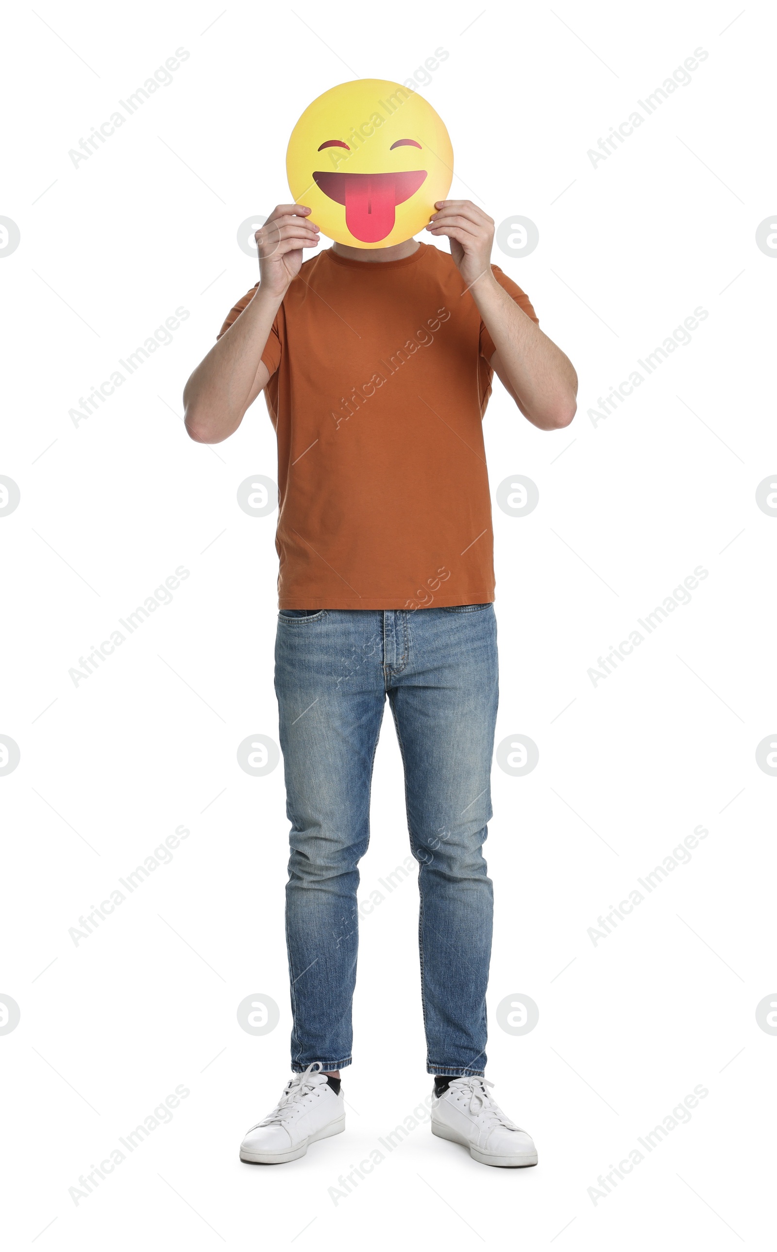 Photo of Man covering face with emoticon sticking out tongue on white background