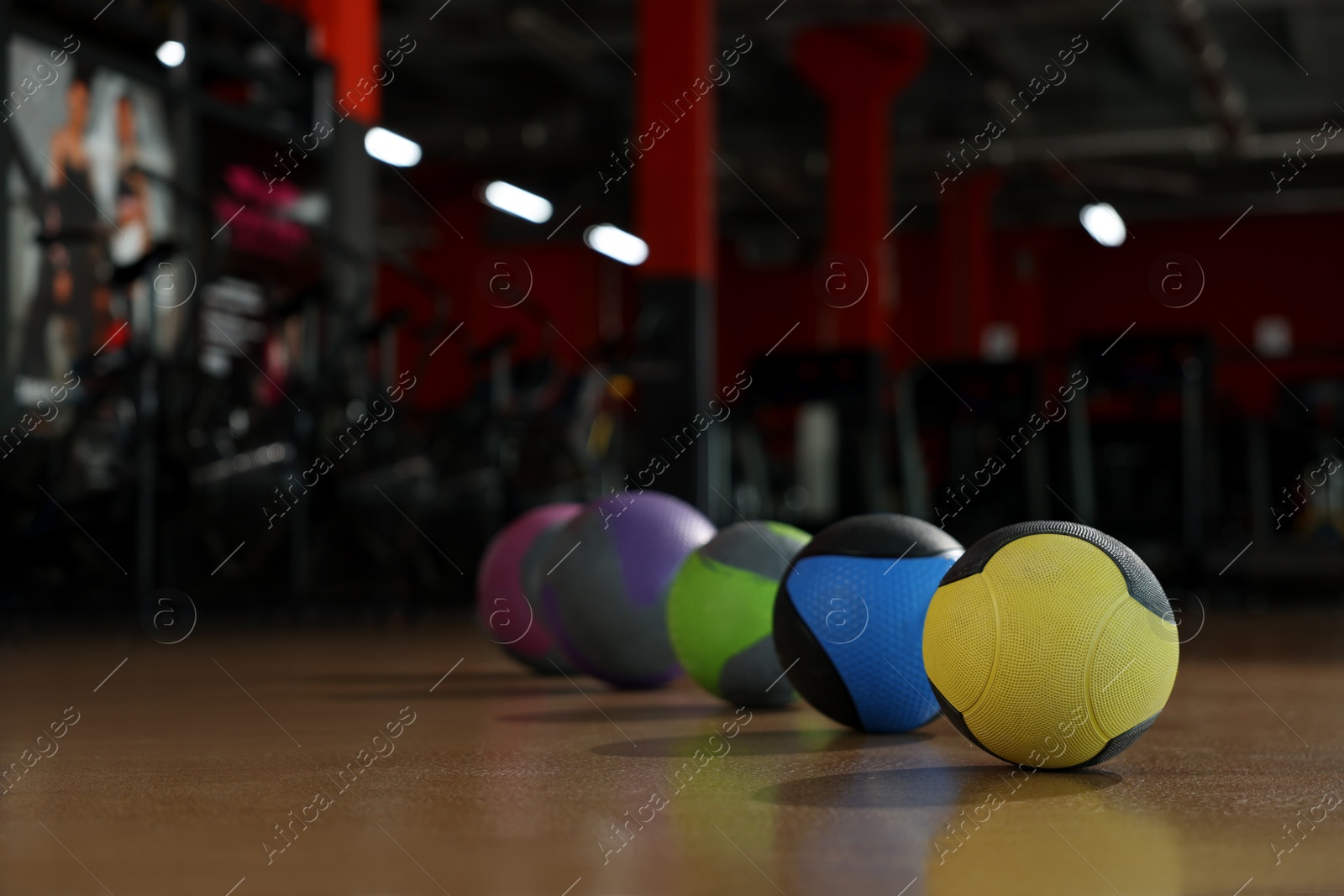 Photo of Medicine balls on floor in gym. Space for text