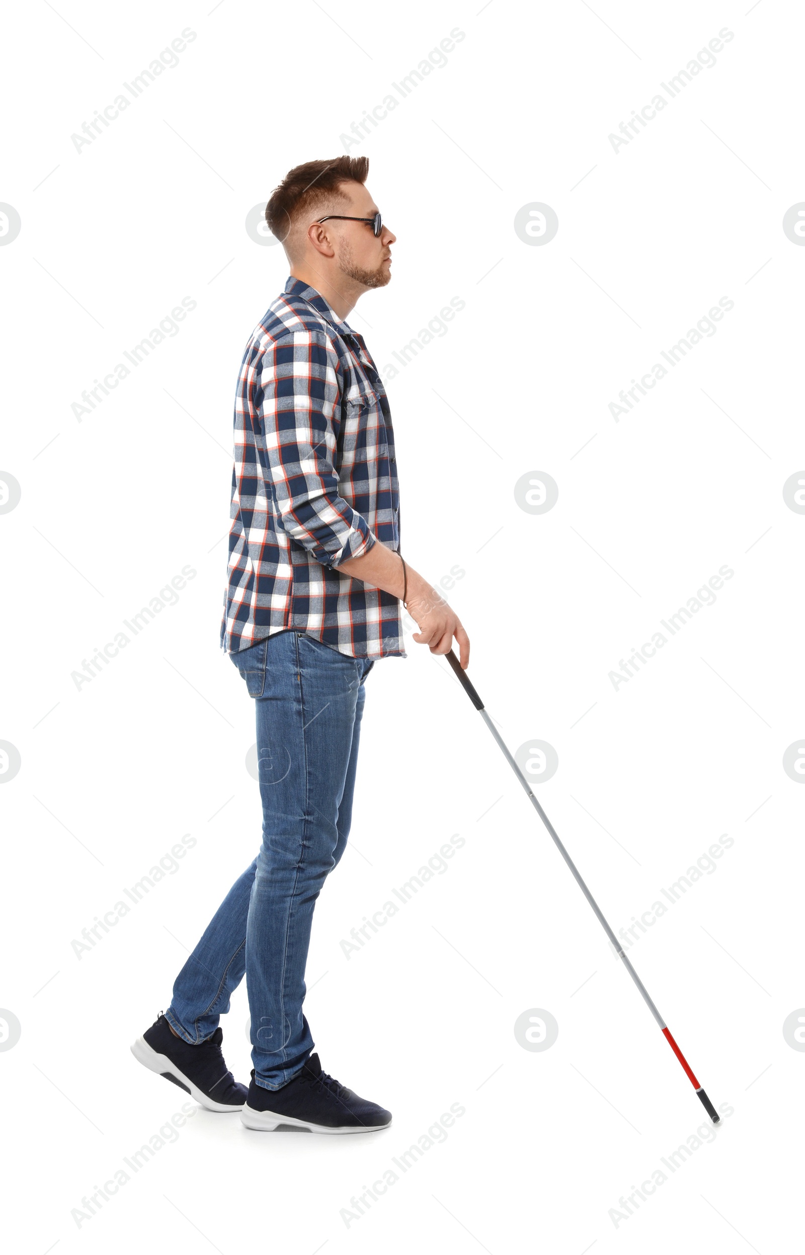 Photo of Blind man in dark glasses with walking cane on white background