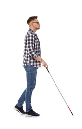 Blind man in dark glasses with walking cane on white background