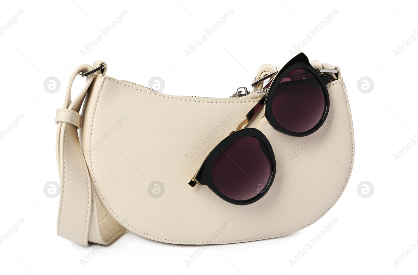 Photo of Stylish baguette bag with sunglasses on white background