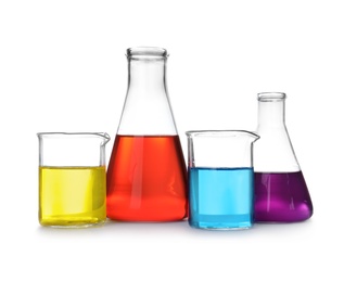 Photo of Laboratory glassware with color liquids on white background