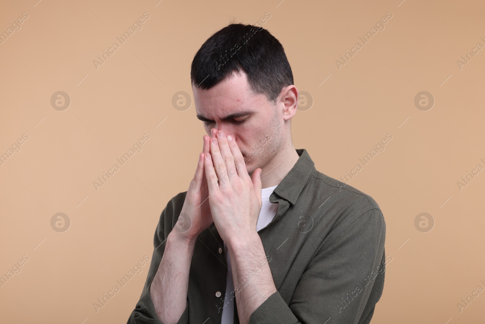 Photo of Portrait of sad man on beige background