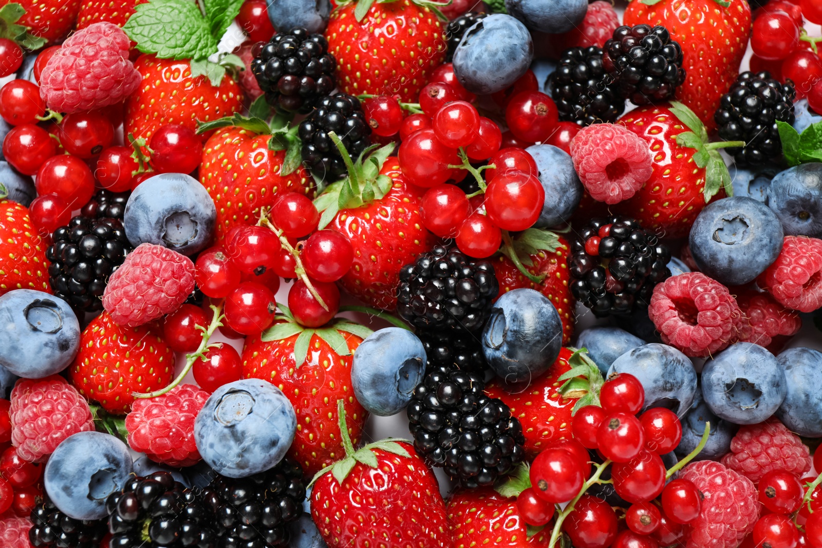 Photo of Mix of fresh delicious berries as background, top view