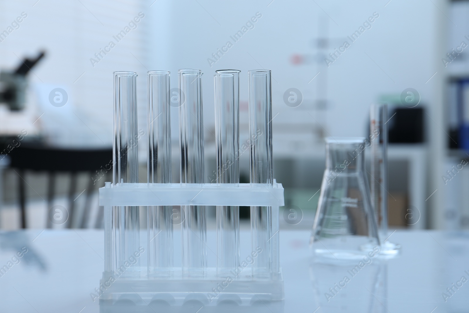 Photo of Laboratory analysis. Glass test tubes on white table indoors