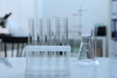 Photo of Laboratory analysis. Glass test tubes on white table indoors