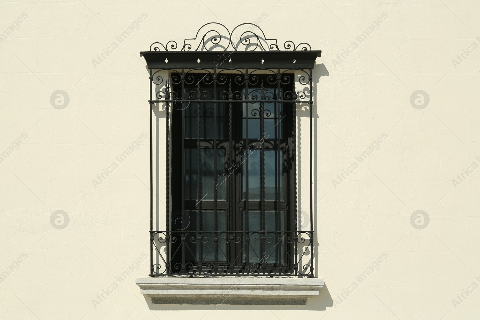 Photo of Beautiful window with grills on building, view from outdoors